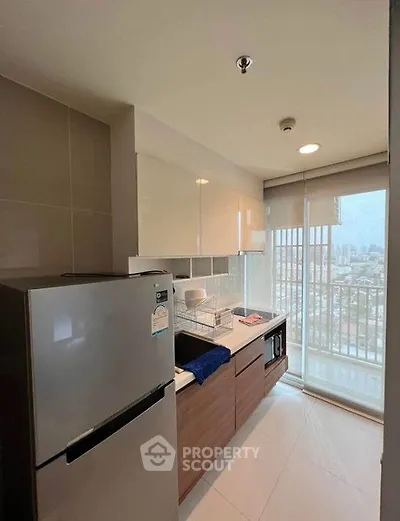 Modern kitchen with sleek cabinets and city view from window