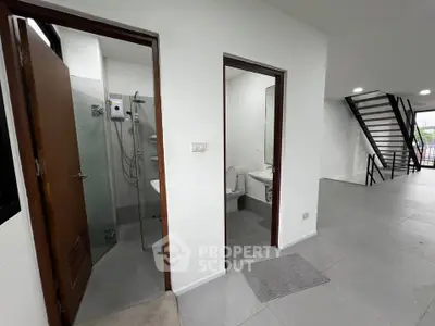 Modern interior with bathroom and staircase, sleek design and open layout