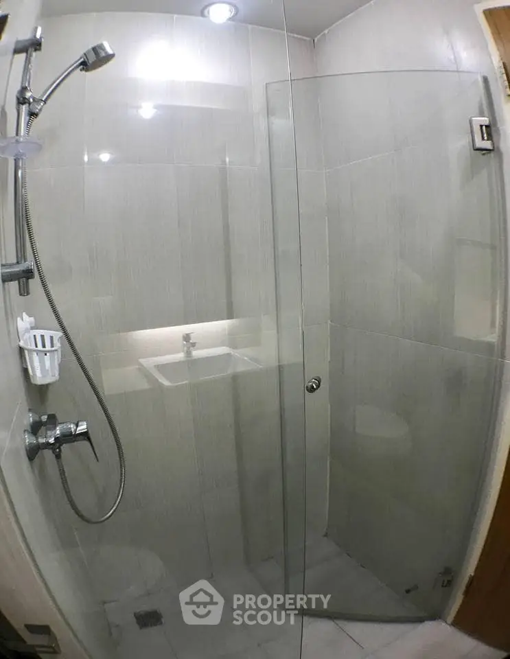 Modern bathroom with glass shower enclosure and sleek fixtures
