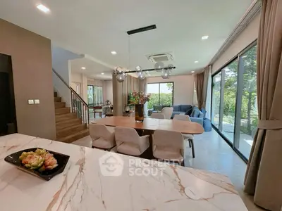 Luxurious open-plan living room with modern decor and garden view