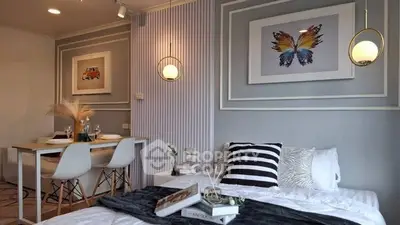 Stylish modern bedroom with dining area, featuring chic decor and cozy ambiance.
