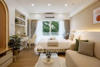 Elegant bedroom with modern decor, large window, and cozy seating area, perfect for relaxation and comfort.
