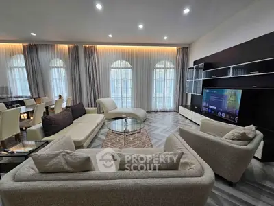 Luxurious living room with modern furniture and large windows in elegant apartment.