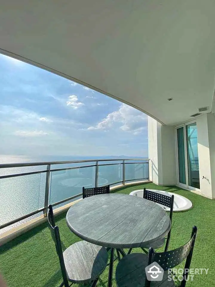 Stunning balcony with ocean view and outdoor seating, perfect for relaxation and enjoying the scenery.