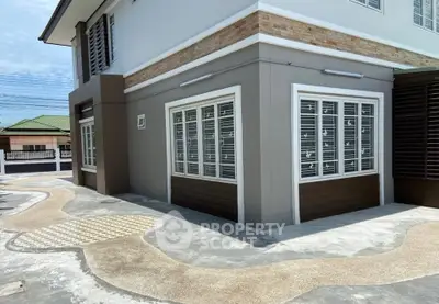 Modern corner unit exterior with stylish windows and unique pavement design.