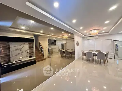 Luxurious open-plan living and dining area with modern decor and elegant lighting