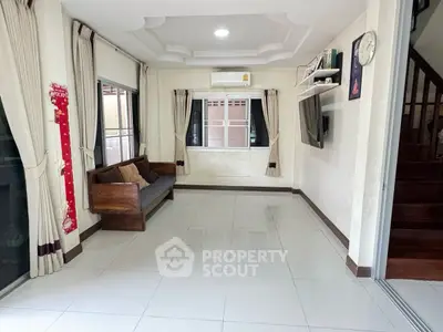 Spacious living room with modern decor and large windows for natural light.