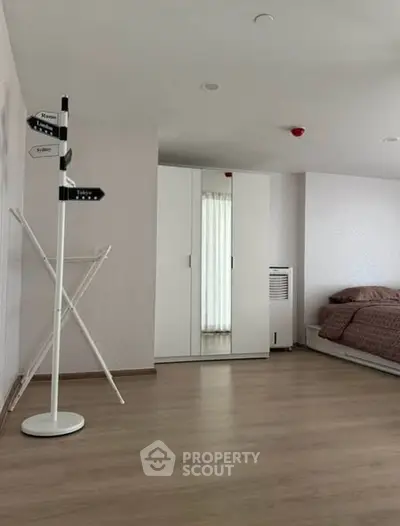 Spacious bedroom with modern decor and ample natural light