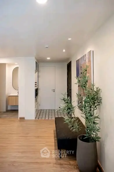 Modern hallway with stylish decor and elegant lighting in a contemporary home.