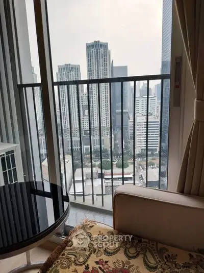 Stunning city view from a modern apartment balcony with elegant furnishings.