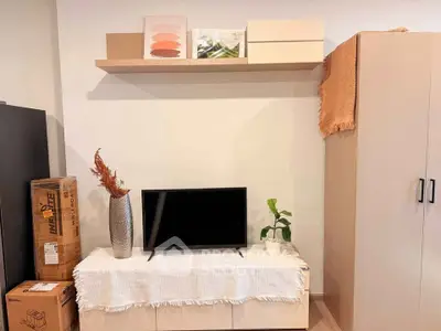 Modern living room with TV, stylish decor, and storage solutions