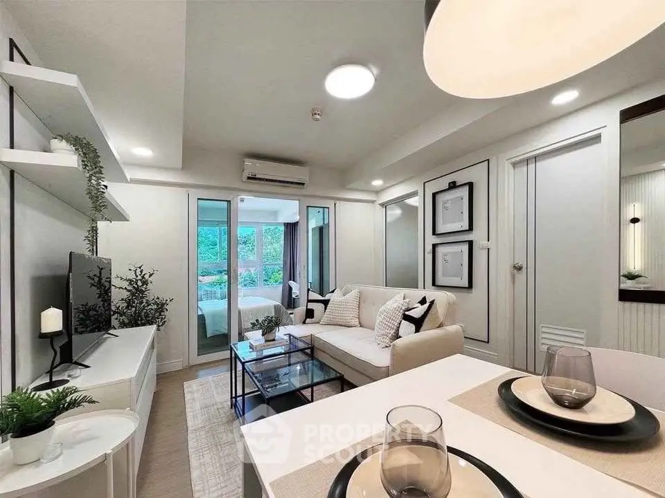 Modern living room with elegant decor and open layout, featuring cozy seating and stylish dining area.
