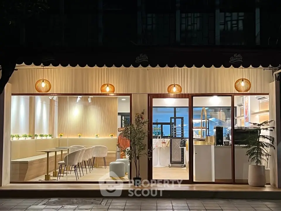 Chic modern cafe exterior with warm lighting and stylish seating, perfect for urban lifestyle enthusiasts.