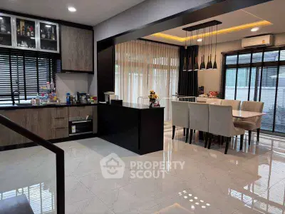 Modern open-layout kitchen and dining area with sleek design and ample natural light.