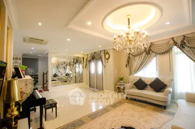 Luxurious living room with elegant chandelier and grand piano, featuring plush seating and exquisite decor.