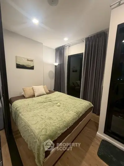 Cozy bedroom with modern decor and large window for natural light