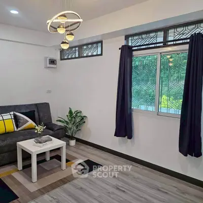 Modern living room with stylish decor and large window view