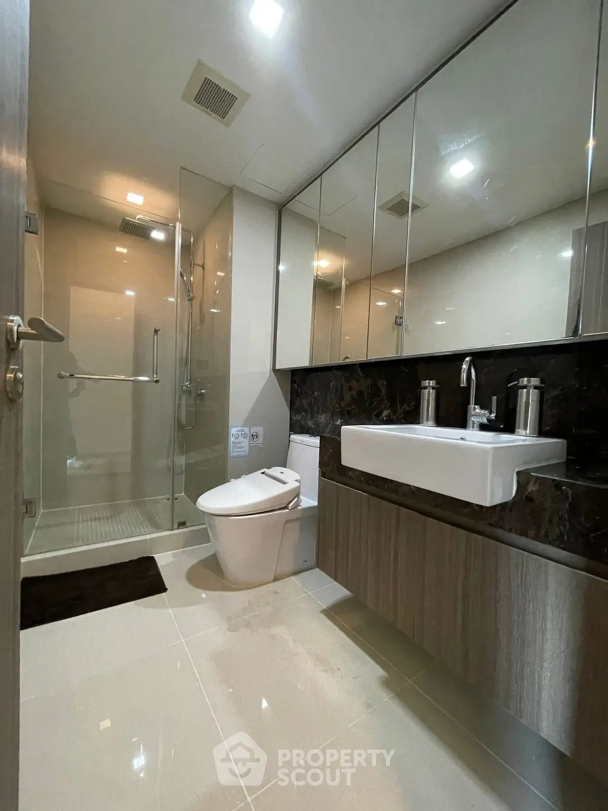 Modern bathroom with sleek fixtures and glass shower enclosure