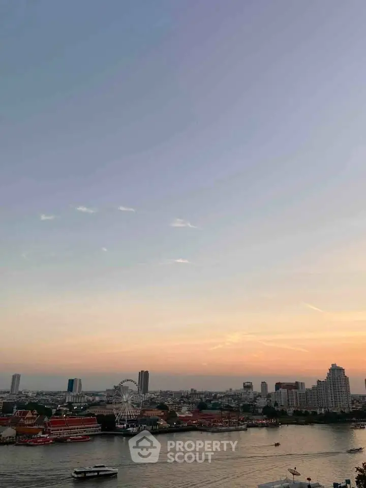 Stunning cityscape view with river and ferris wheel at sunset, perfect for urban living enthusiasts.