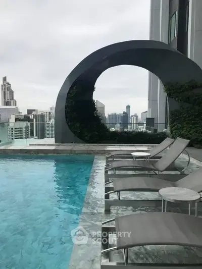 Luxurious rooftop pool with stunning city skyline views and modern lounge chairs.