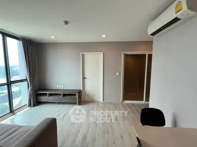 Spacious modern living room with large windows and sleek flooring