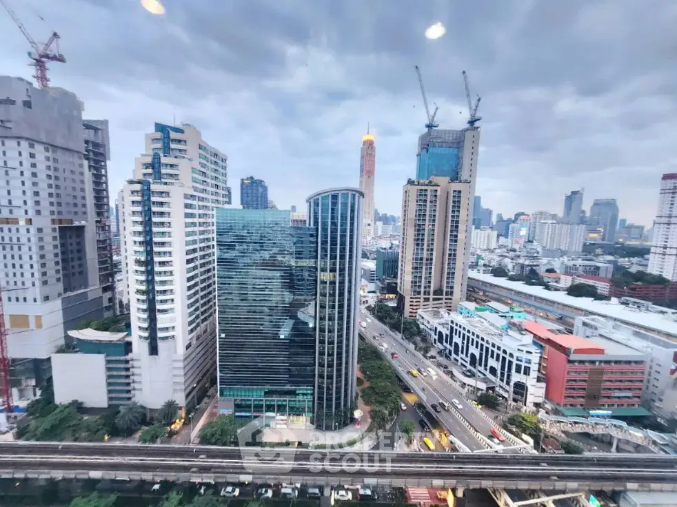 Stunning cityscape view from high-rise building with modern architecture and bustling streets below.