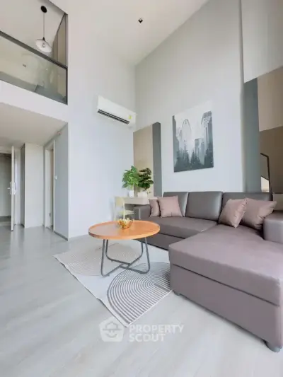 Modern living room with high ceiling and stylish decor in a contemporary apartment.