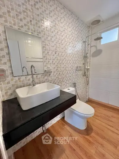 Modern bathroom with stylish sink and shower in a contemporary home.