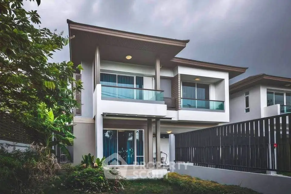 Modern two-story house with sleek design and lush garden