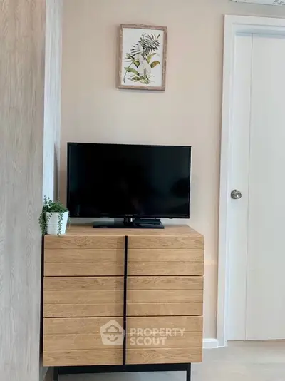 Modern minimalist living room with sleek TV stand and wall art