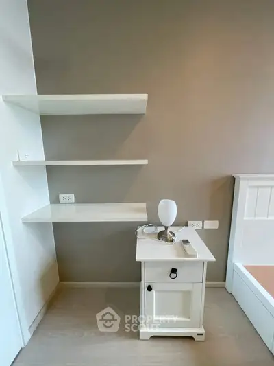 Modern bedroom with sleek white shelves and stylish nightstand, perfect for minimalist living.