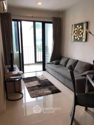 Modern living room with sleek furniture and balcony access in a stylish apartment.
