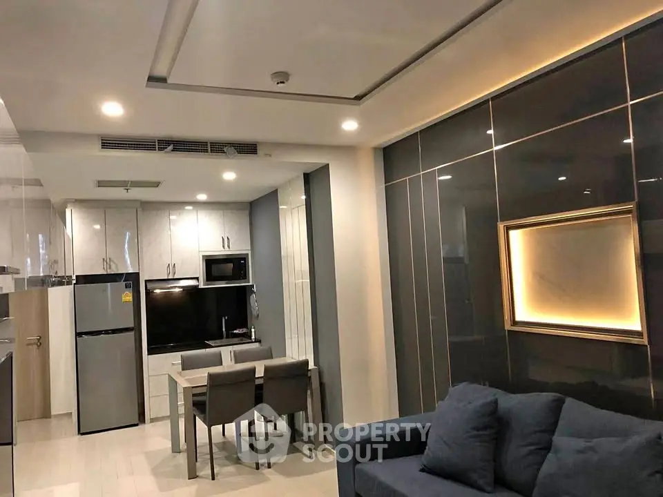 Modern open-plan living room and kitchen with sleek design and contemporary furniture.