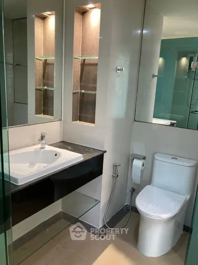 Modern bathroom with sleek fixtures and glass shower enclosure