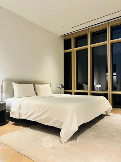 Luxurious modern bedroom with large windows and elegant decor