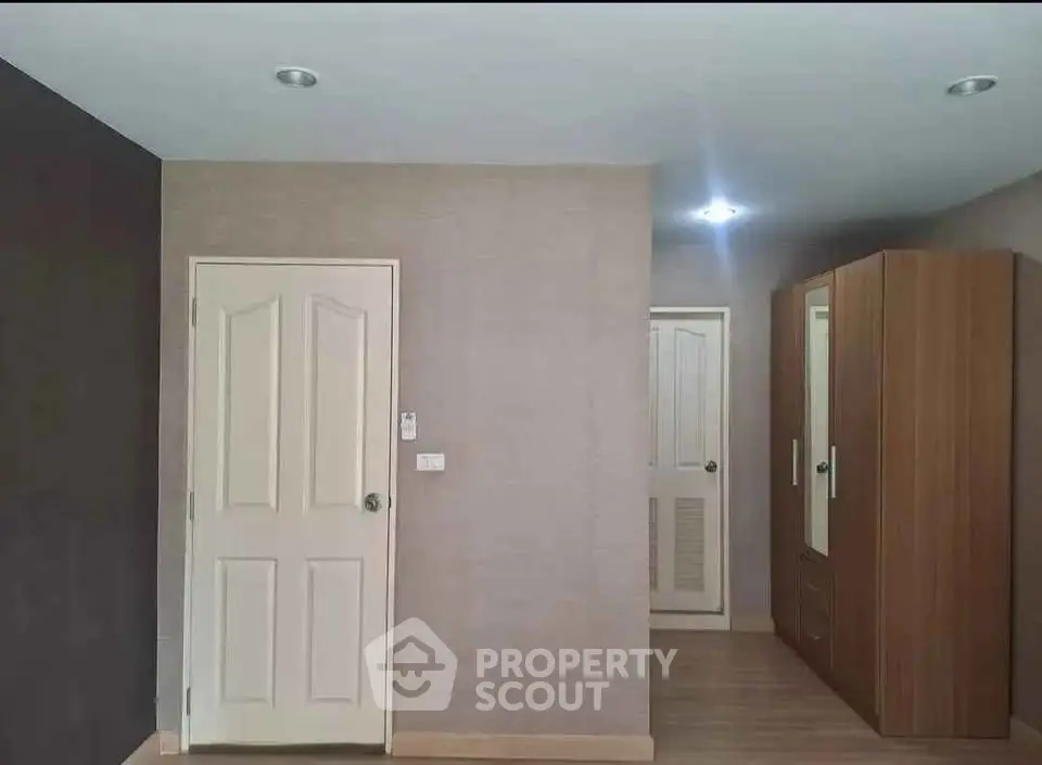 Spacious bedroom with modern wardrobe and neutral wall tones