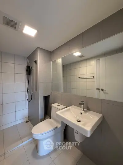 Modern bathroom with sleek fixtures and spacious shower area