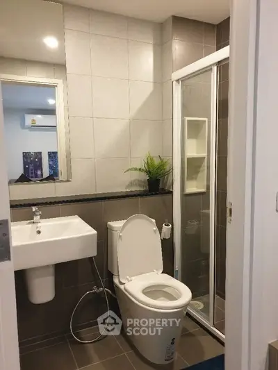 Modern bathroom with sleek design featuring a glass shower and contemporary fixtures.