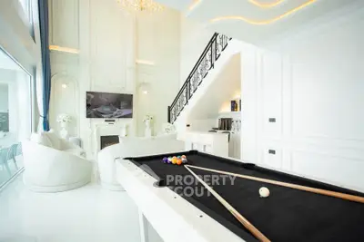 Luxurious living room with pool table and elegant decor