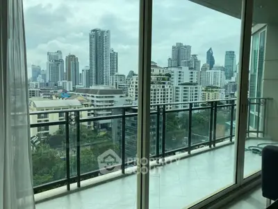 Spacious balcony with stunning city skyline view in modern high-rise apartment.