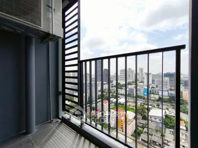 Stunning city view from a high-rise balcony with modern railing design.