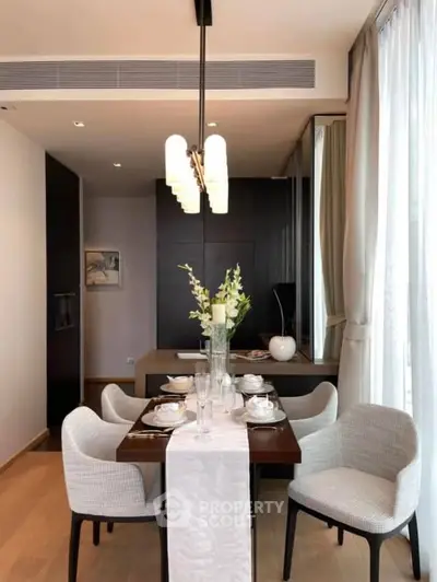 Elegant dining area with modern decor and natural light, perfect for intimate gatherings.