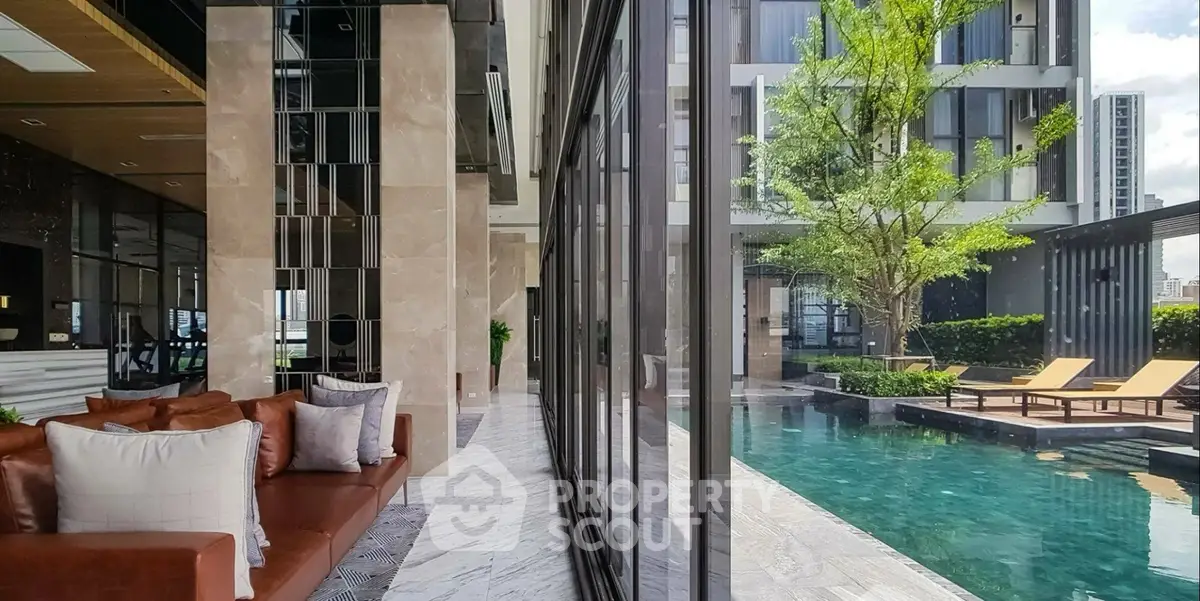 Luxurious poolside view with modern architecture and elegant outdoor seating.