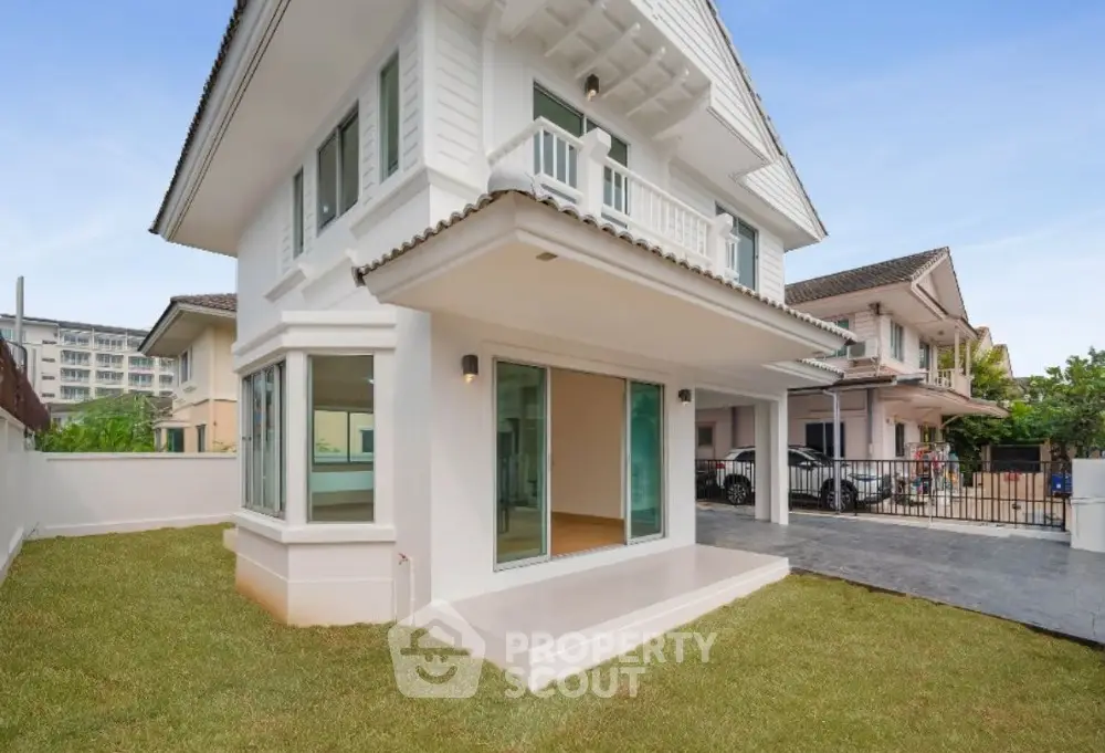 Charming two-story house with spacious lawn and modern design in a serene neighborhood.