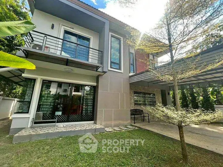 Modern two-story house with lush garden and balcony