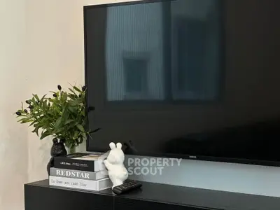 Modern living room with sleek TV setup and stylish decor accents.