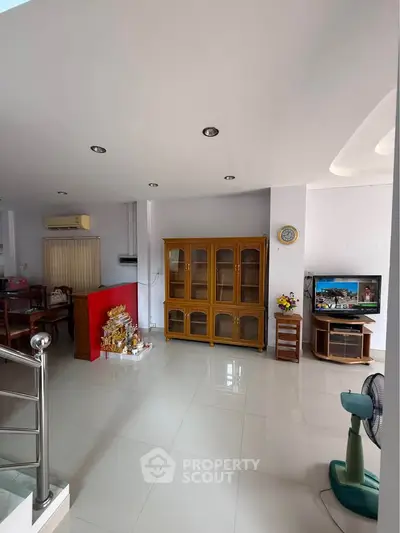 Spacious living room with modern decor and ample natural light