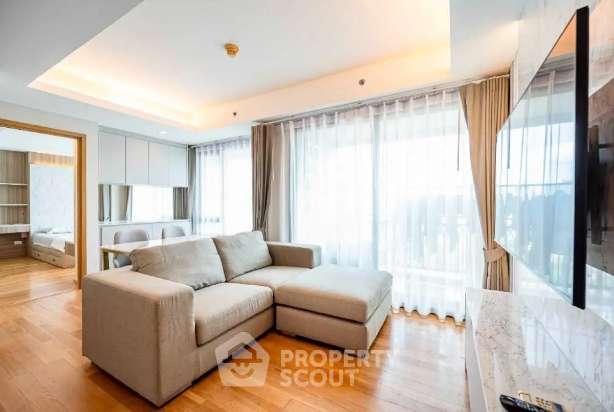Spacious modern living room with large windows and cozy sectional sofa
