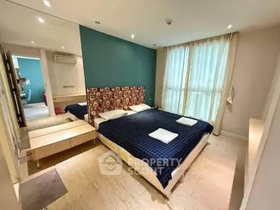 Spacious bedroom with modern decor and large windows for natural light.