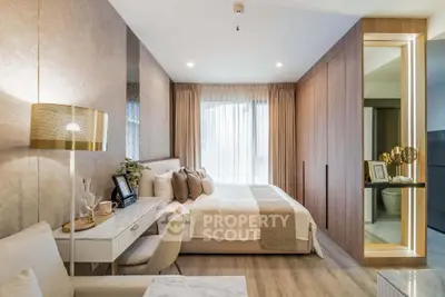 Luxurious modern bedroom with elegant decor and natural light, featuring a cozy seating area and stylish furnishings.